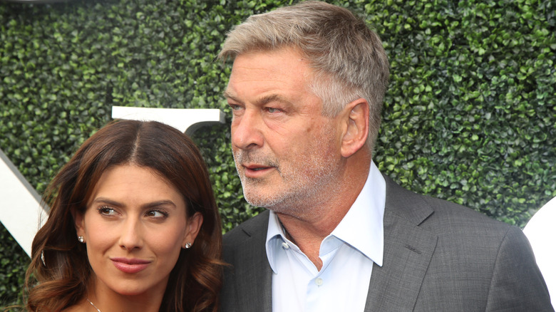 Hilaria Baldwin with husband Alec Baldwin posing in front of leaves