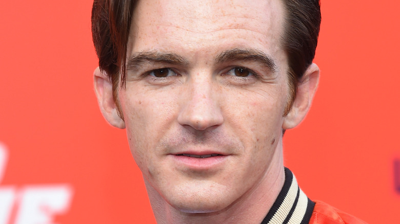 Drake Bell in red jacket