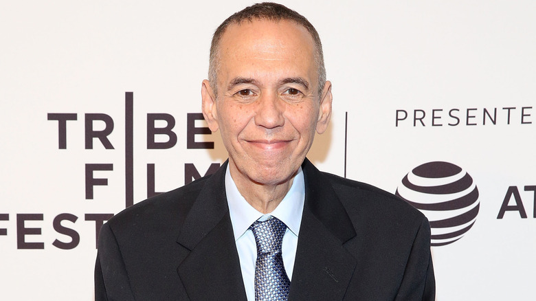 Gilbert Gottfried wearing a black suit with a silver patterned tie