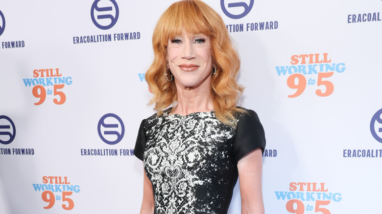 Kathy Griffin wearing a black cap sleeve dress with a white lace pattern