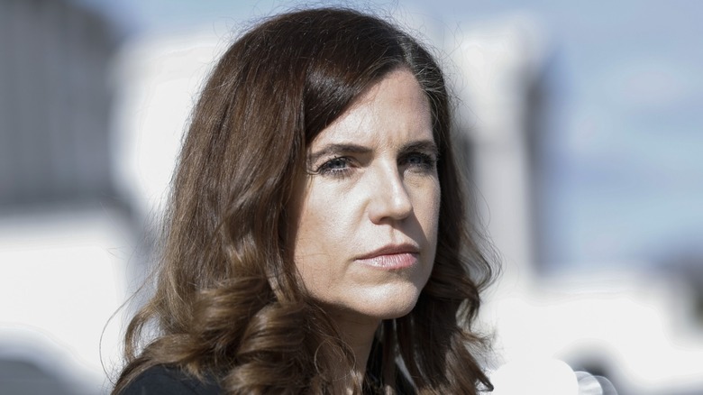 Sporting spiky lashes, Nancy Mace looks directly into the camera.