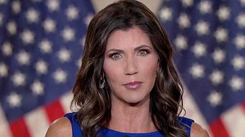 Kristi Noem wearing her hair styled in long curls and sporting a glossy lip while delivering her 2020 RNC speech.