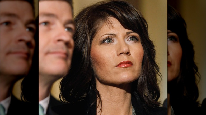Kristi Noem pictured in March 2011 looking up and wearing coral-colored lipstick.
