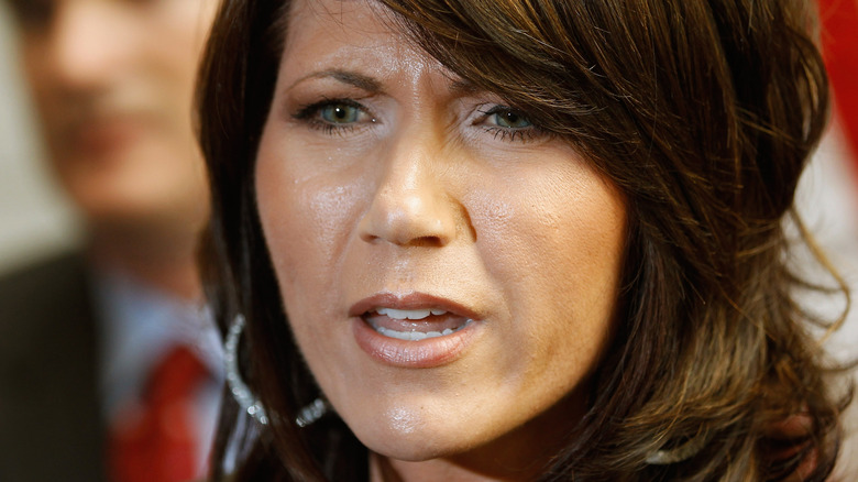 Closeup of Kristi Noem frowning with pale lipstick and much darker lip liner in June 2011.