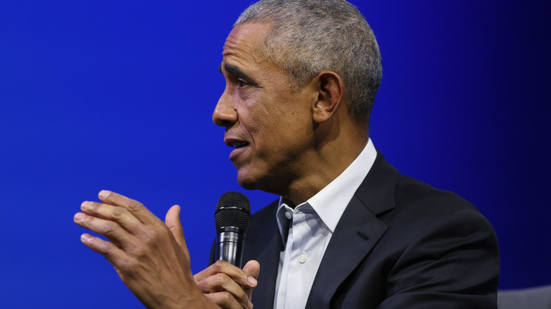 Barack Obama speaks into a microphone