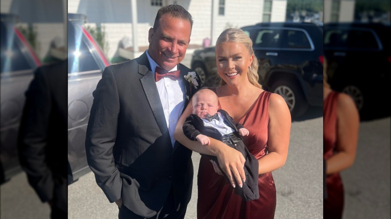 Karoline Leavitt and Nicholas Riccio pose with their son at a wedding.