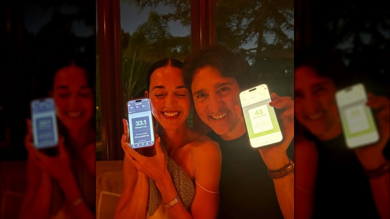 Katy Perry and Justin Trudeau posing with their phones.