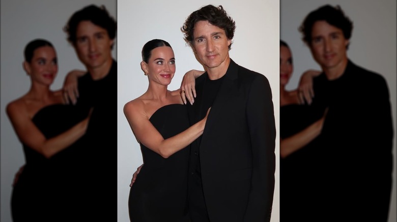 Katy Perry gazes at Justin Trudeau as they pose together.