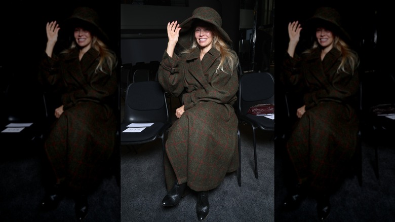 Pamela Anderson sitting at the Vivienne Westwood Womenswear Spring/Summer 2024 show