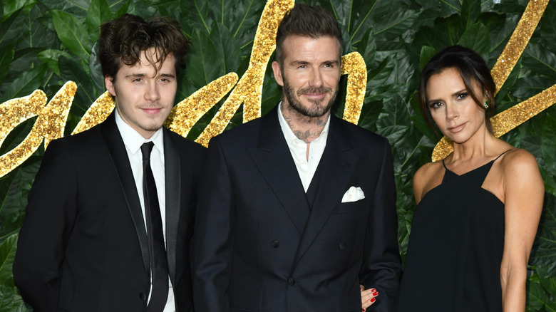 Brooklyn Beckham with parents David Beckham and Victoria Beckham