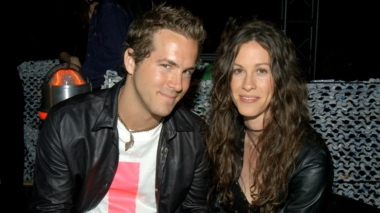Ryan Reynolds sitting with Alanis Morrissette