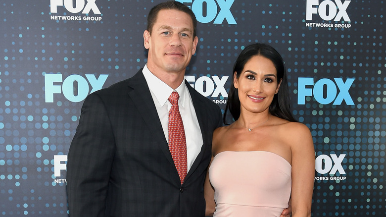 John Cena and Nikki Bella pose in front of a Fox Networks backdrop