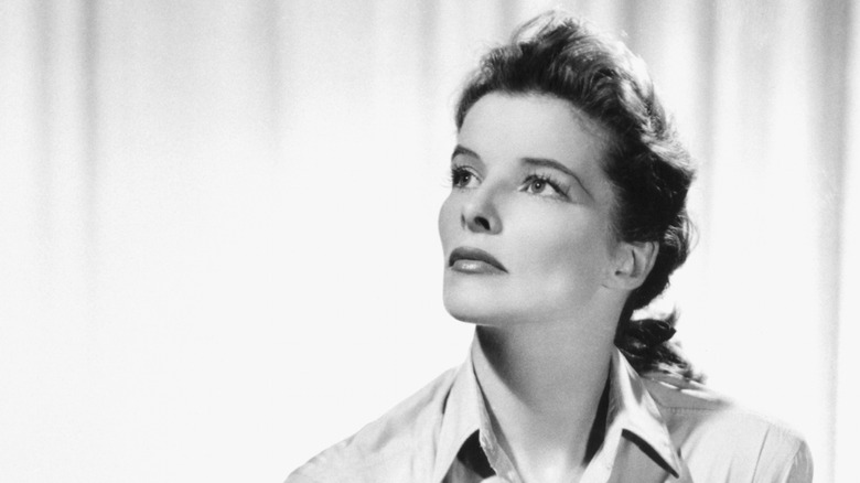 Katharine Hepburn in a black and white photograph looking skyward off camera