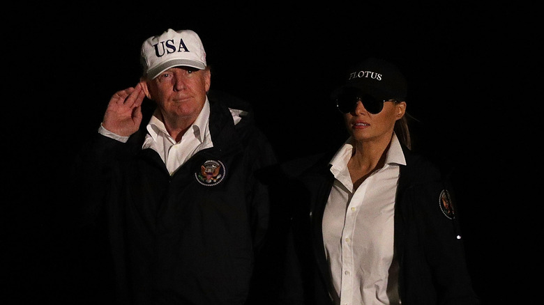 Melania Trump and Donald Trump wearing baseball hats in Texas
