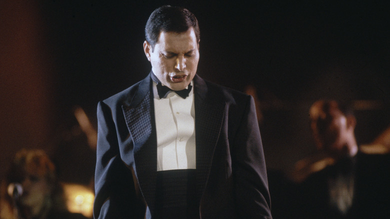 Freddie Mercury performing, looking down