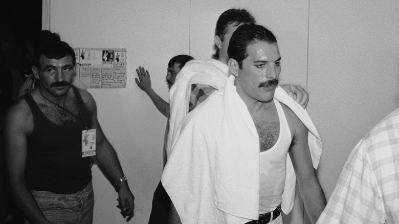 Freddie Mercury walking with boyfriend Jim Hutton