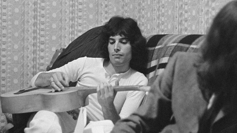 Freddie Mercury playing guitar