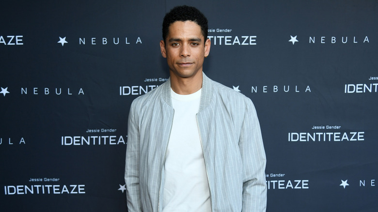 Charle Barnett posing in front of black backdrop