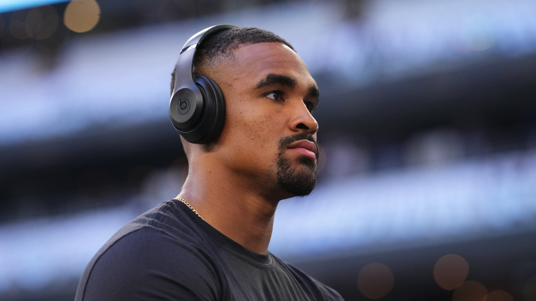 Jalen Hurts wearing headphones, looking away