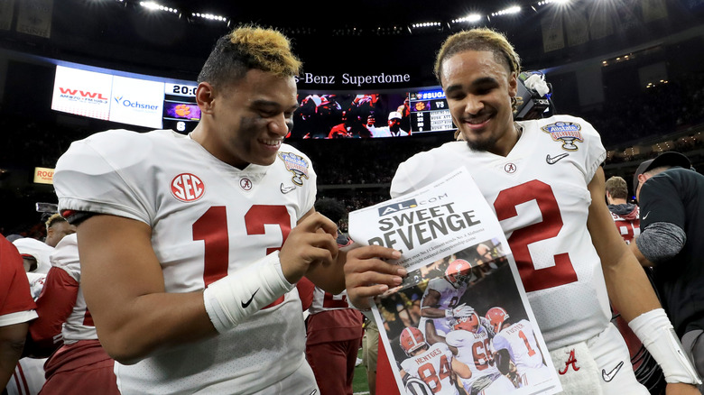Jalen Hurts and Tua Tagovailoa hold newspaper