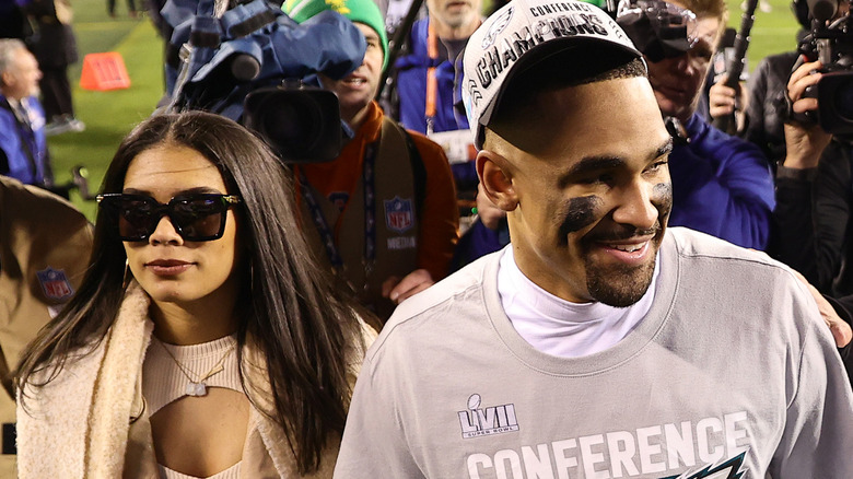 Jalen Hurts walking beside Bryonna Burrows