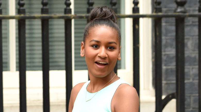 Sasha Obama looks away from the camera, her mouth wide open.