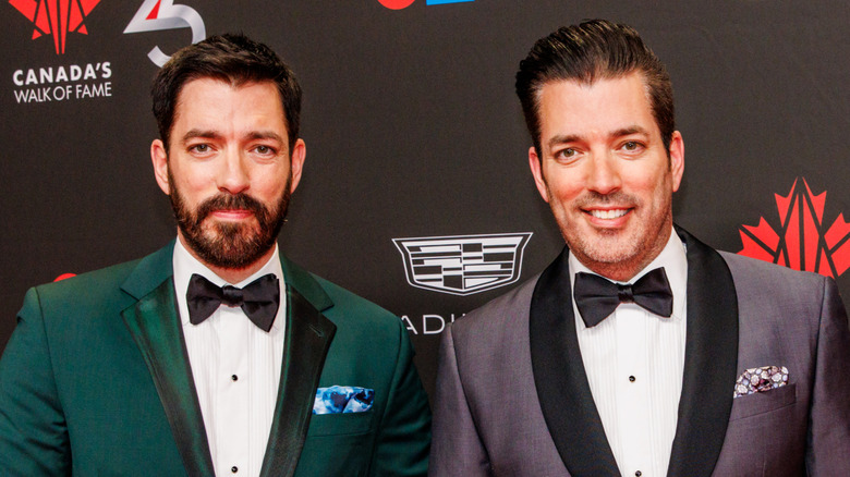 Property Brothers posing and smiling on red carpet