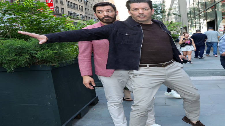 Jonathan Scott blocking Drew Scott while walking on the street