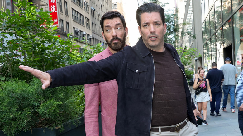 Jonathan Scott blocking Drew Scott while walking on the street