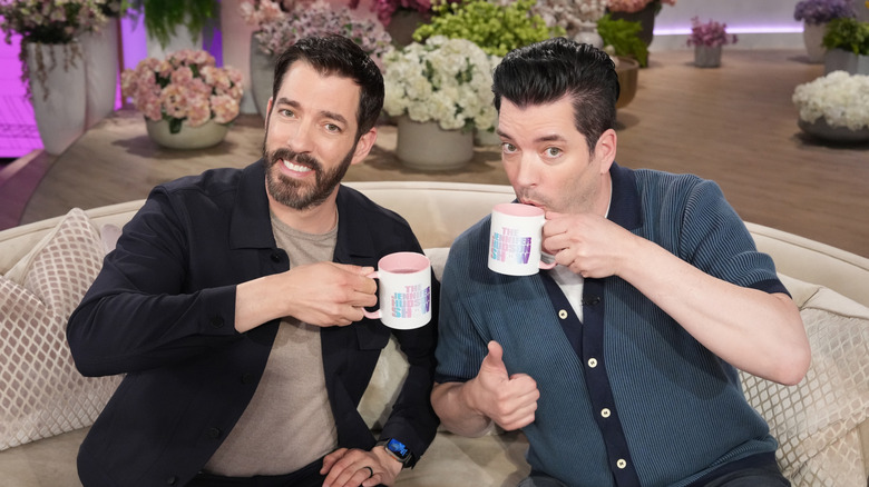 Property Brothers holding coffee mugs