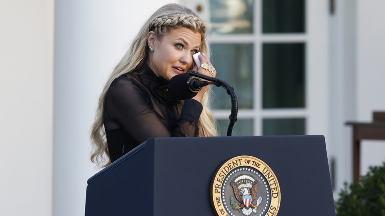 Erika Kirk, wife of late conservative activist Charlie Kirk, becomes emotional as she speaks at a podium