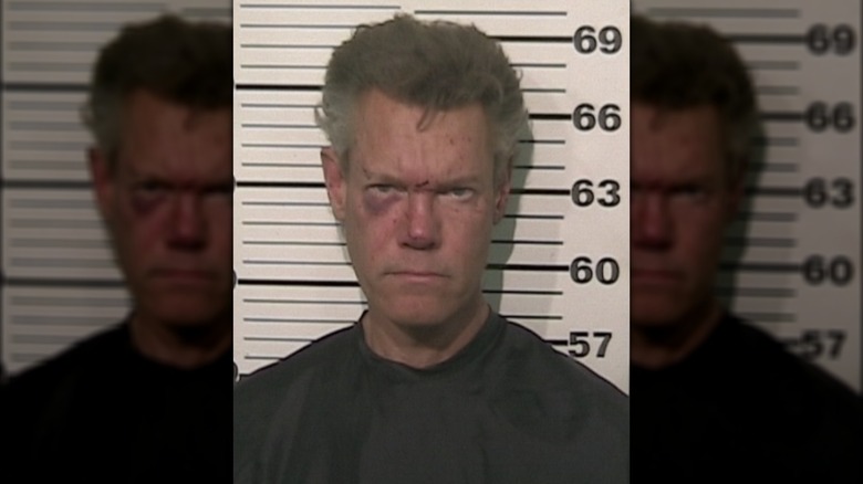 Randy Travis scowling in mugshot