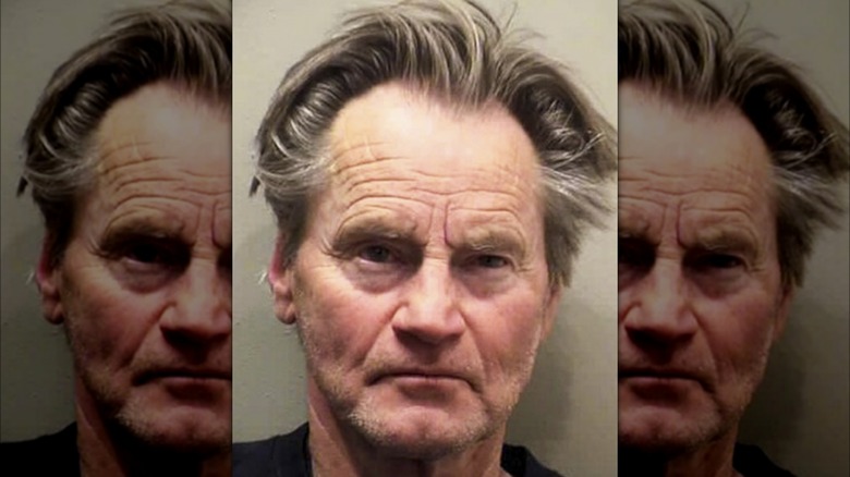 Sam Shepard frowning in mugshot