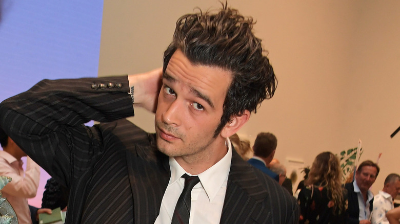 Matt Healy with his arm behind his head