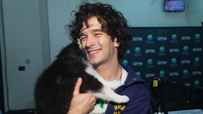 Matt Healy holding a puppy