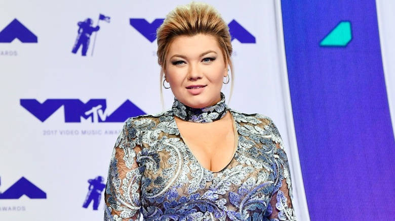 Amber Portwood dazzles in a patterned see-through dress while looking away from the camera.
