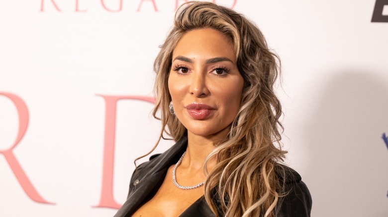 Sporting wavy hair and a black leather jacket, Farrah Abraham gazes at the camera while pouting her lips