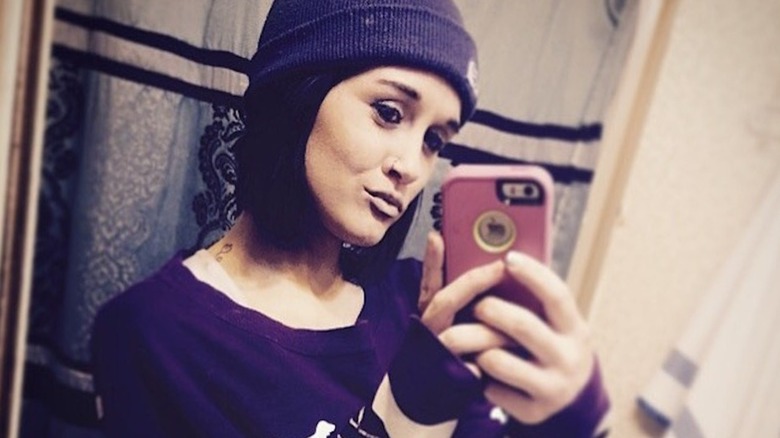 Wearing an all-black beenie and a similar sweatshirt, Jordan Cashmyer pouts her mouth as she takes a selfie.