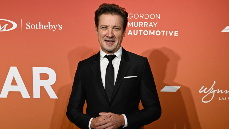 Jeremy Renner posing in a suit