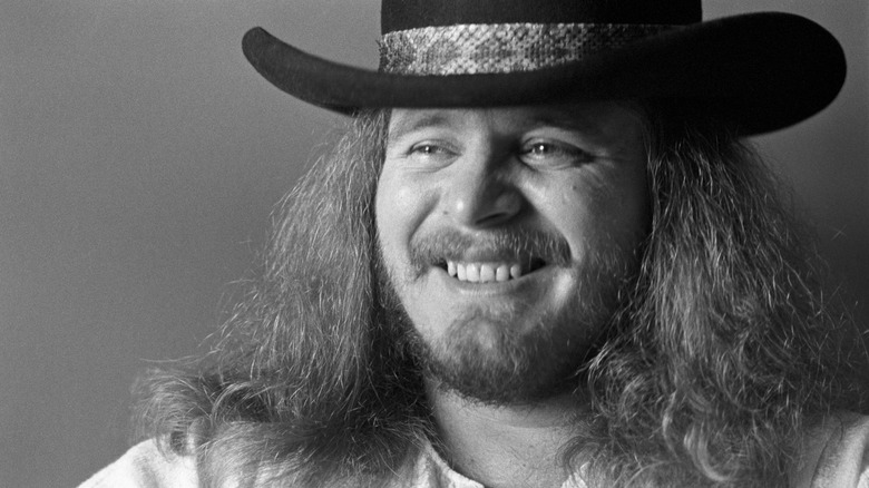 Ronnie Van Zant posing for black and white portrati