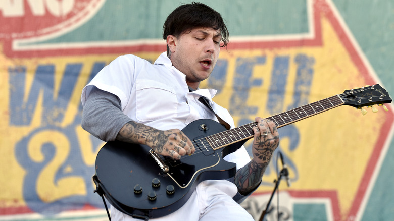 Frank Iero playing guitar on stage