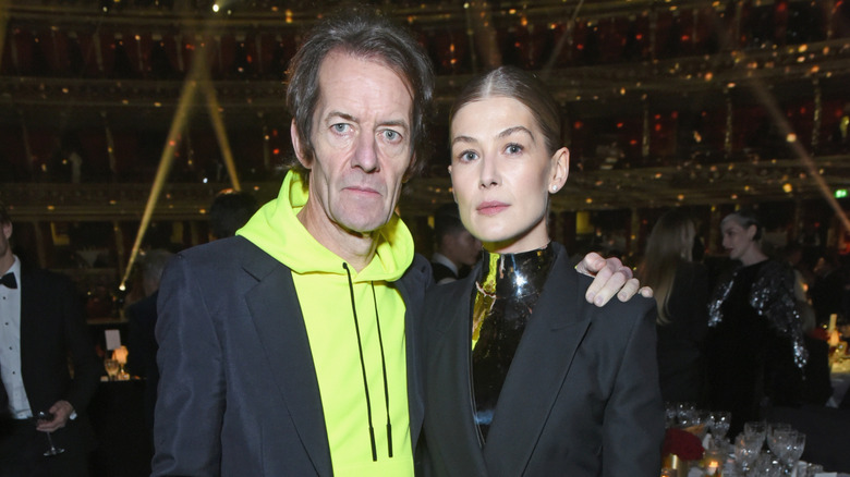 Robie Uniacke posing with his arm around Rosamund Pike.