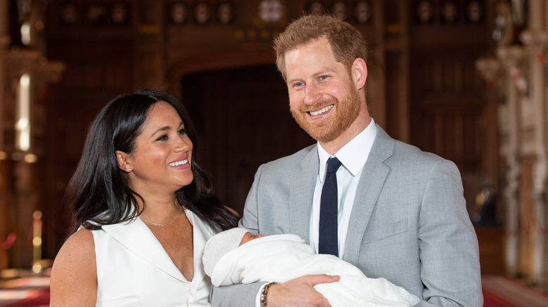 Prince Harry and Meghan Markle hold newborn Archie