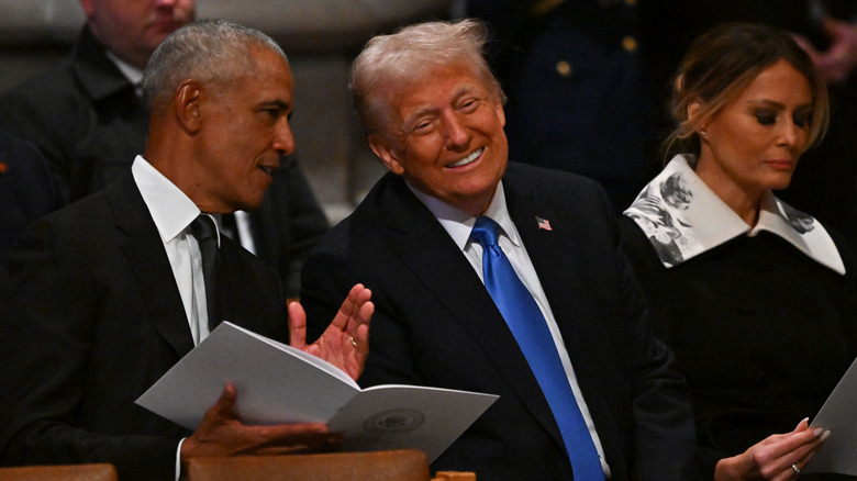 Former President Barack Obama and President-elect Donald Trump speaking together ahead of the state funeral services for former President Jimmy Carter at the National Cathedral