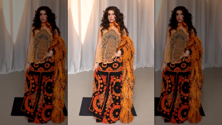 Odessa A'zion wearing black and orange at the 6th Annual Academy Museum Gala