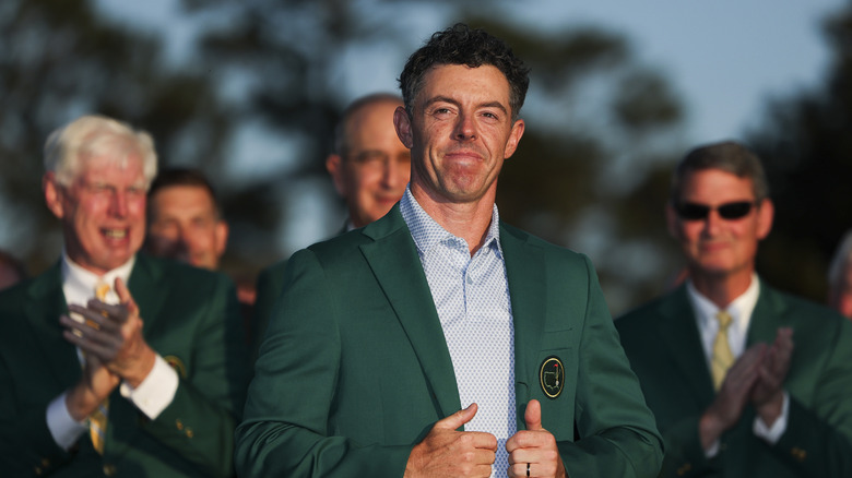 Rory McIlroy is awarded a green jacket after winning the 2026 Masters