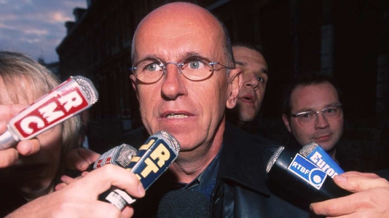 Willy Voet surrounded by microphones