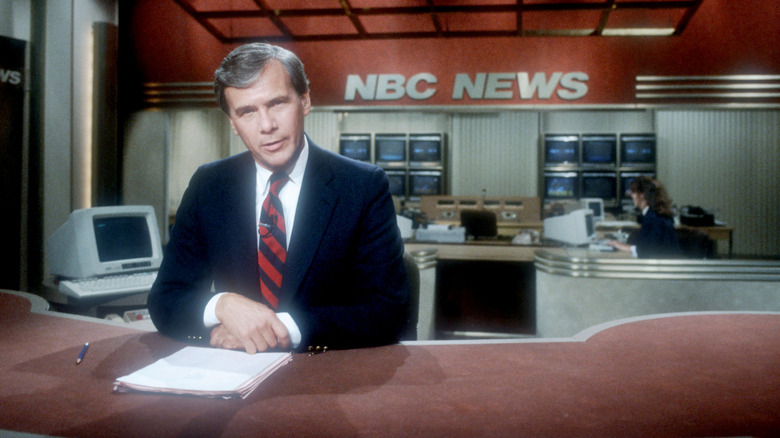 Tom Brokaw sitting at his NBC News desk