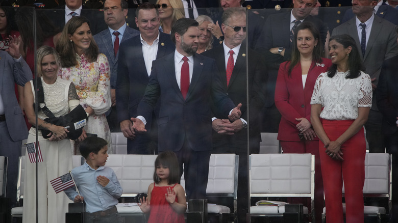 Vice President JD Vance gesturing to Usha Vance as they watch the military parade