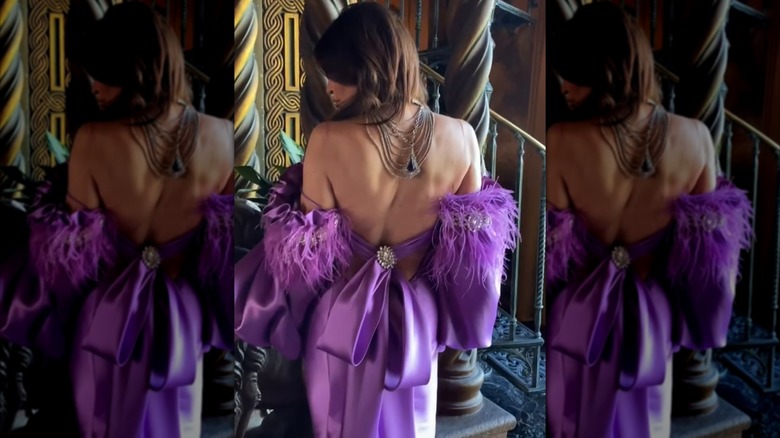 Kimberly Guilfoyle modeling the back of a designer dress